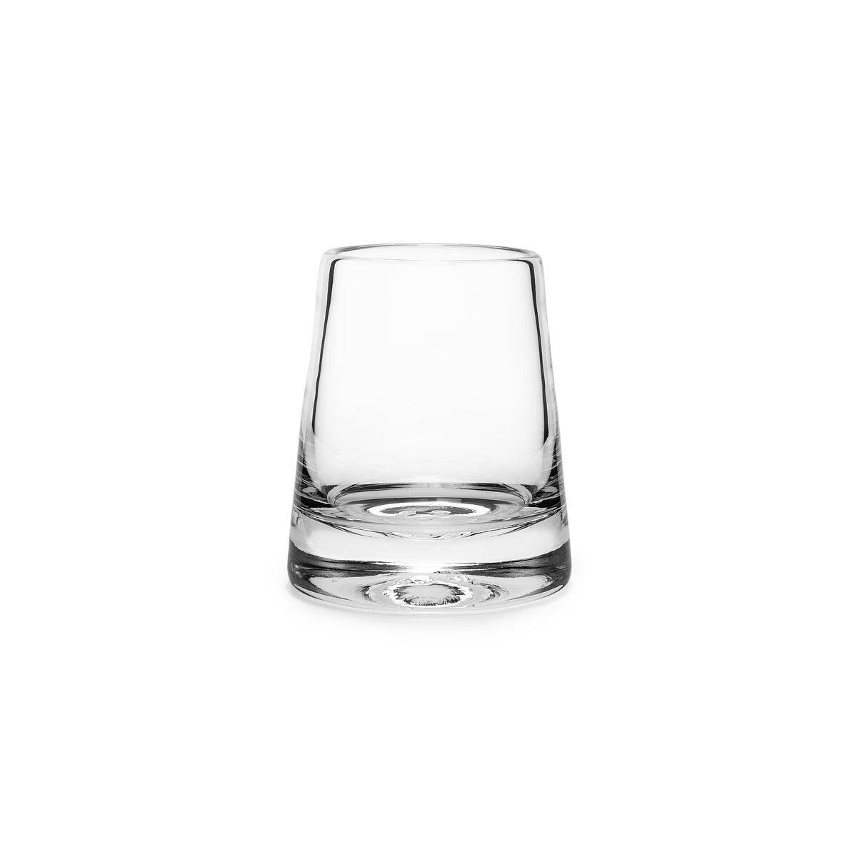 Clear glass tumbler with thick base and tapered sides, empty against white background.