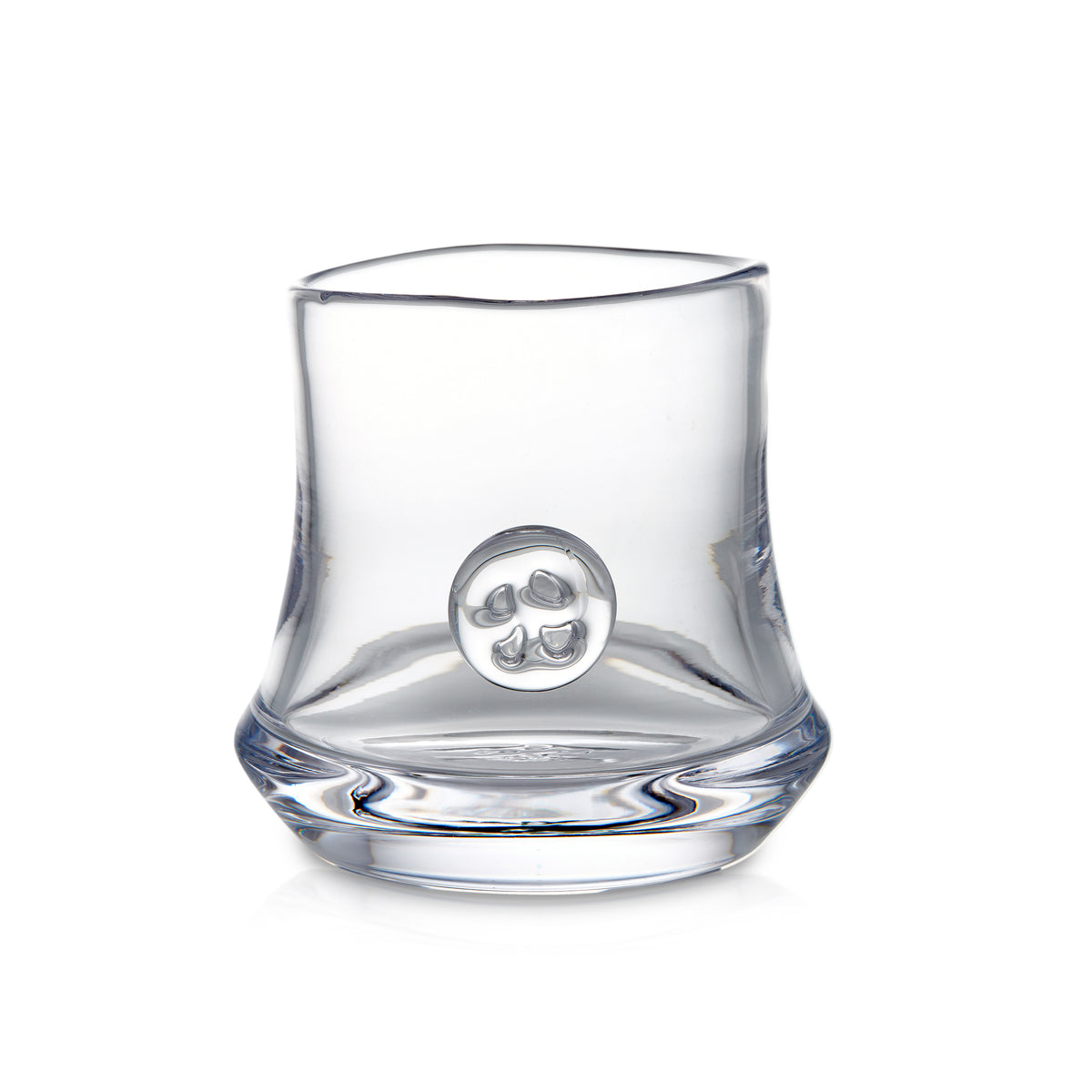 Clear glass tumbler with curved sides and circular medallion detail on front.