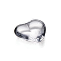 Clear glass heart-shaped object with smooth curved surface and reflective finish.