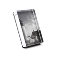 Vertical acrylic photo block displaying black and white lighthouse with attached building image.