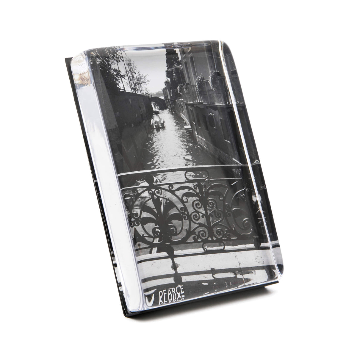 Clear acrylic photo block with black and white canal street scene featuring ornate railing, displayed at an angle.