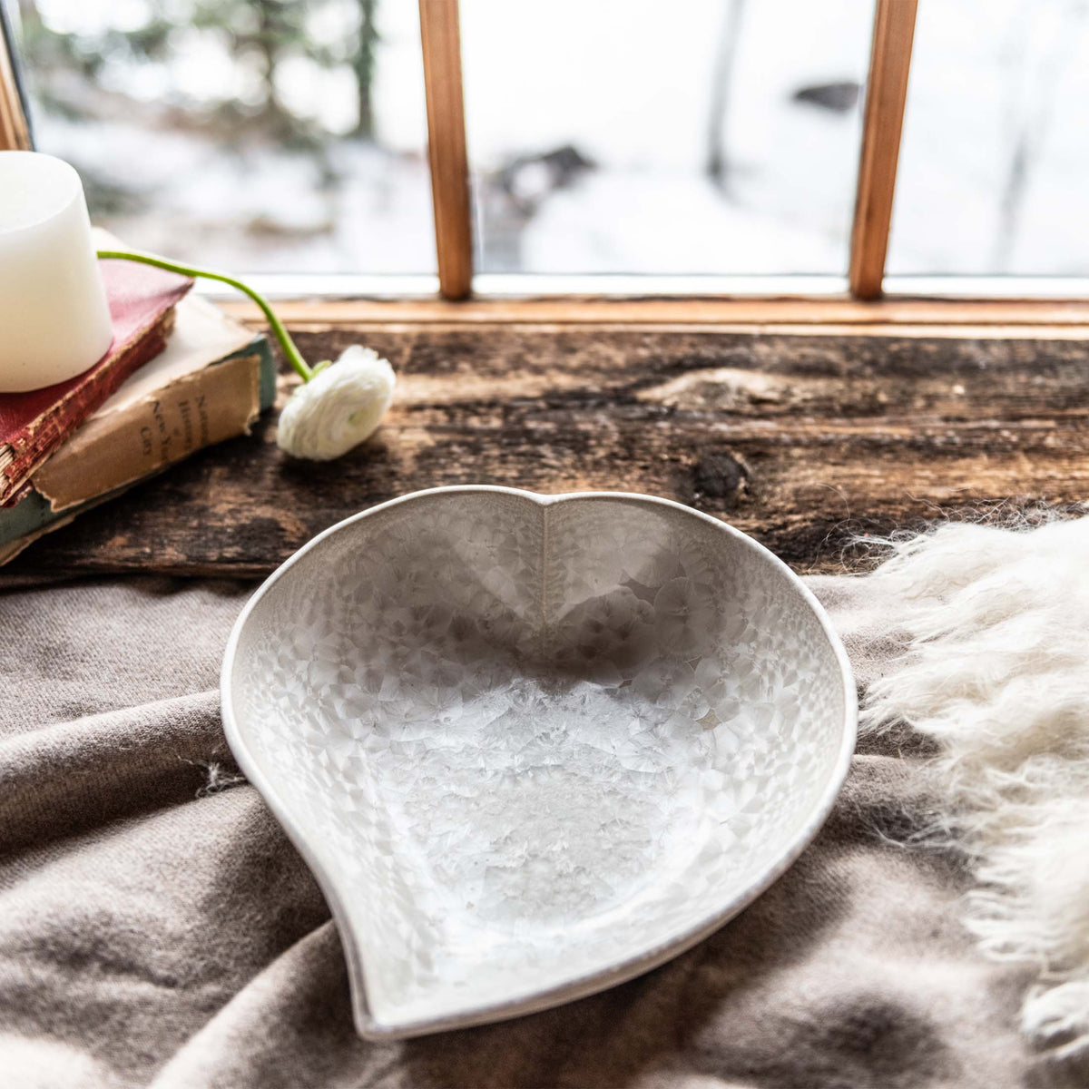 White ceramic heart-shaped bowl with textured crystalline interior pattern.