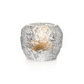 Silver textured spherical tealight holder with cutout details and warm-toned interior.