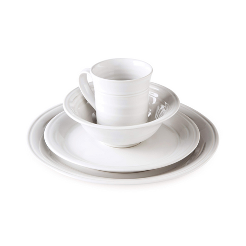 White ceramic dinnerware place setting with dinner plate, bowl, saucer, and mug stacked together.