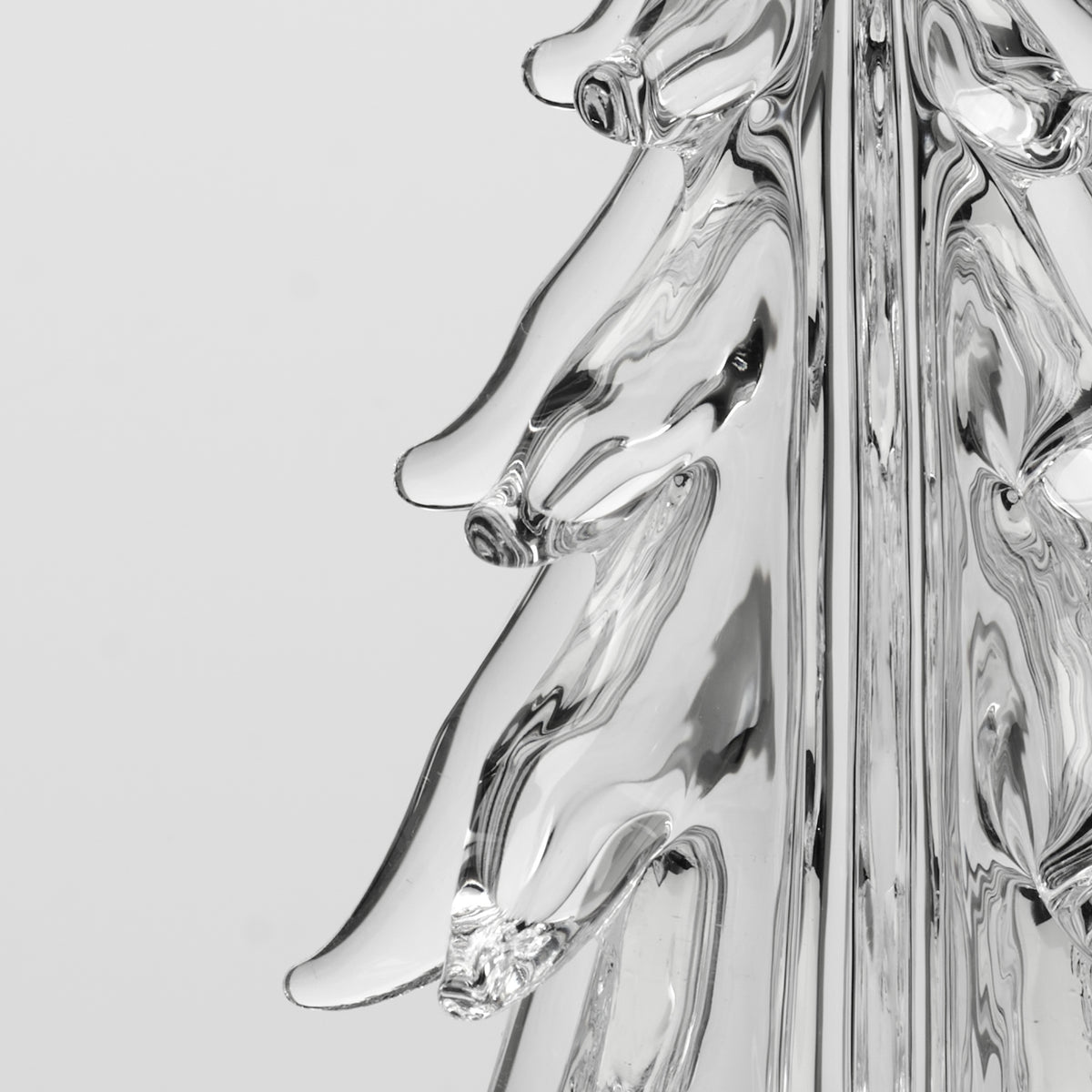 Clear glass sculptural form with five curved sides and organic flowing surfaces, displayed against white background.