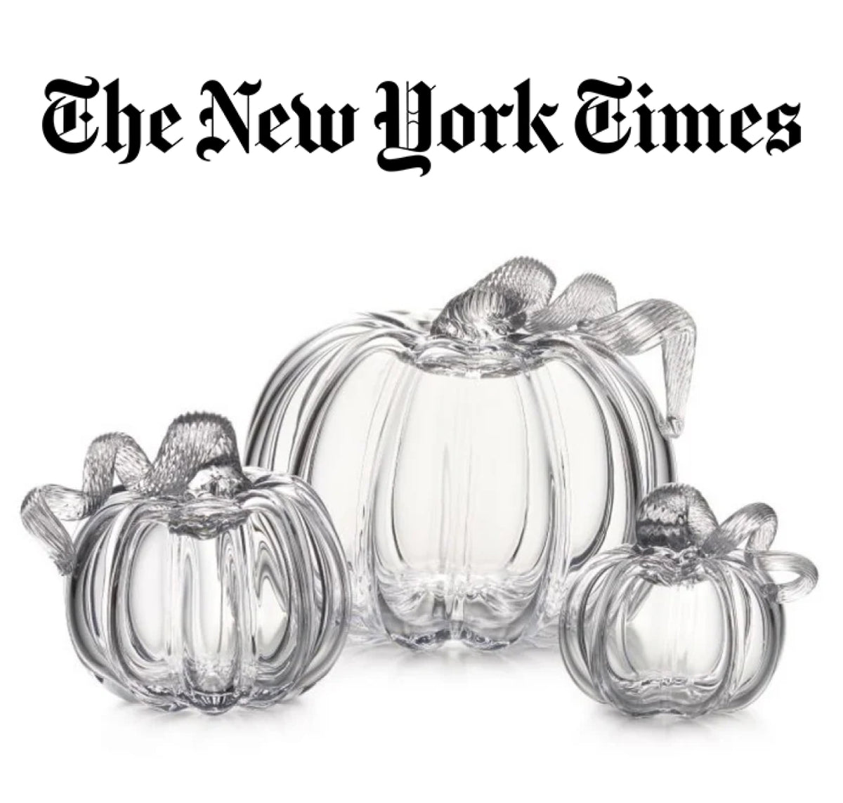 The New York Times feature: Three Simon Pearce handblown clear glass pumpkins in small, medium, and large sizes, with delicate textured stems, on a white background