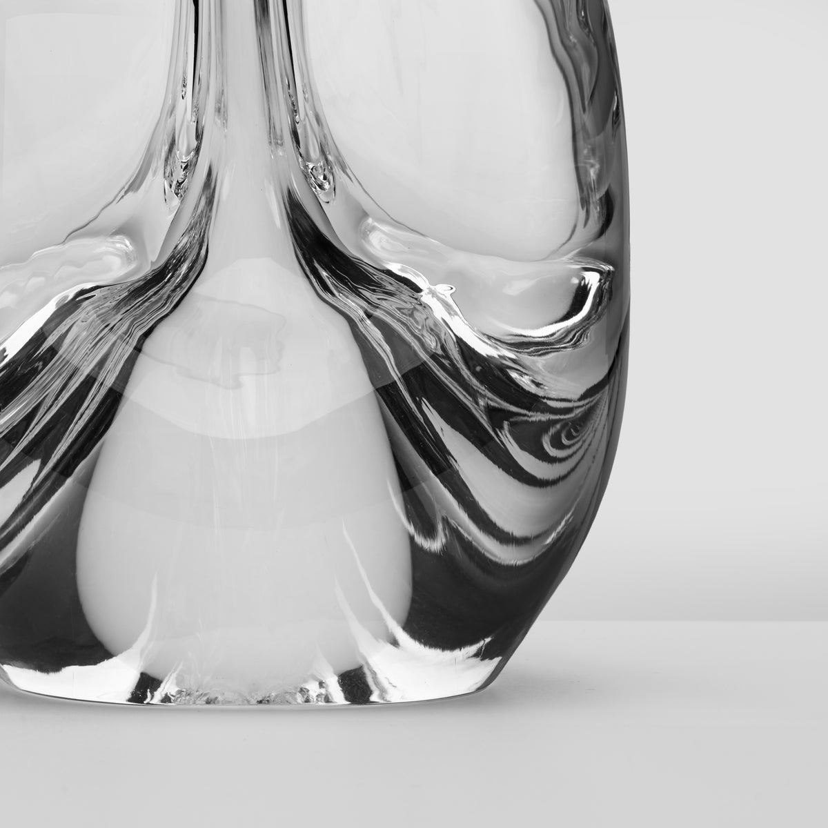 Clear glass spiral tree sculpture with three curved sides and black striped detailing.