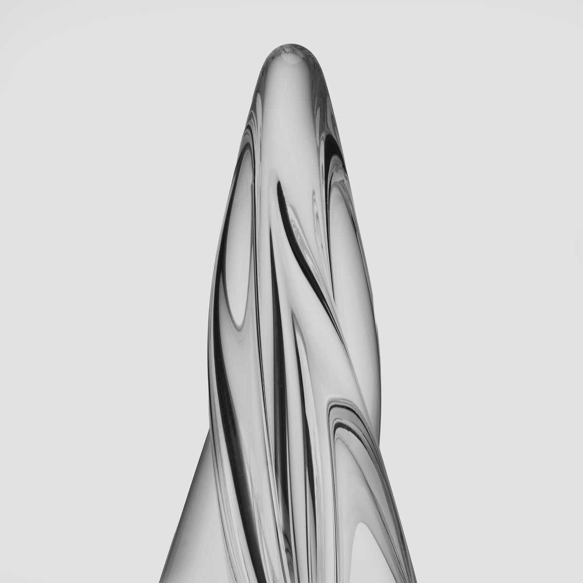 Tall spiral tree sculpture with four-sided twisted design in clear glass or acrylic.