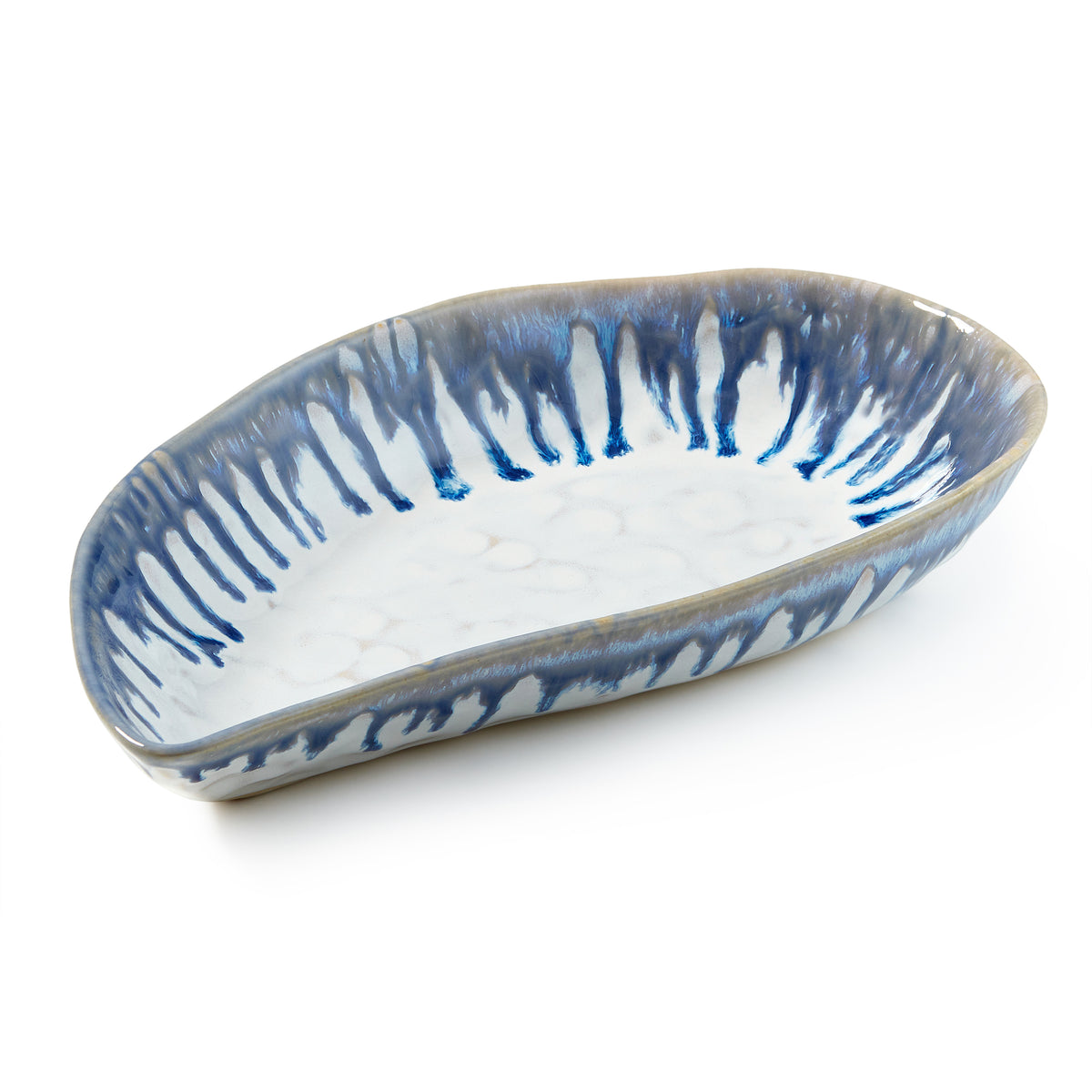Blue and white mussel shell-shaped ceramic bowl with striped pattern interior.