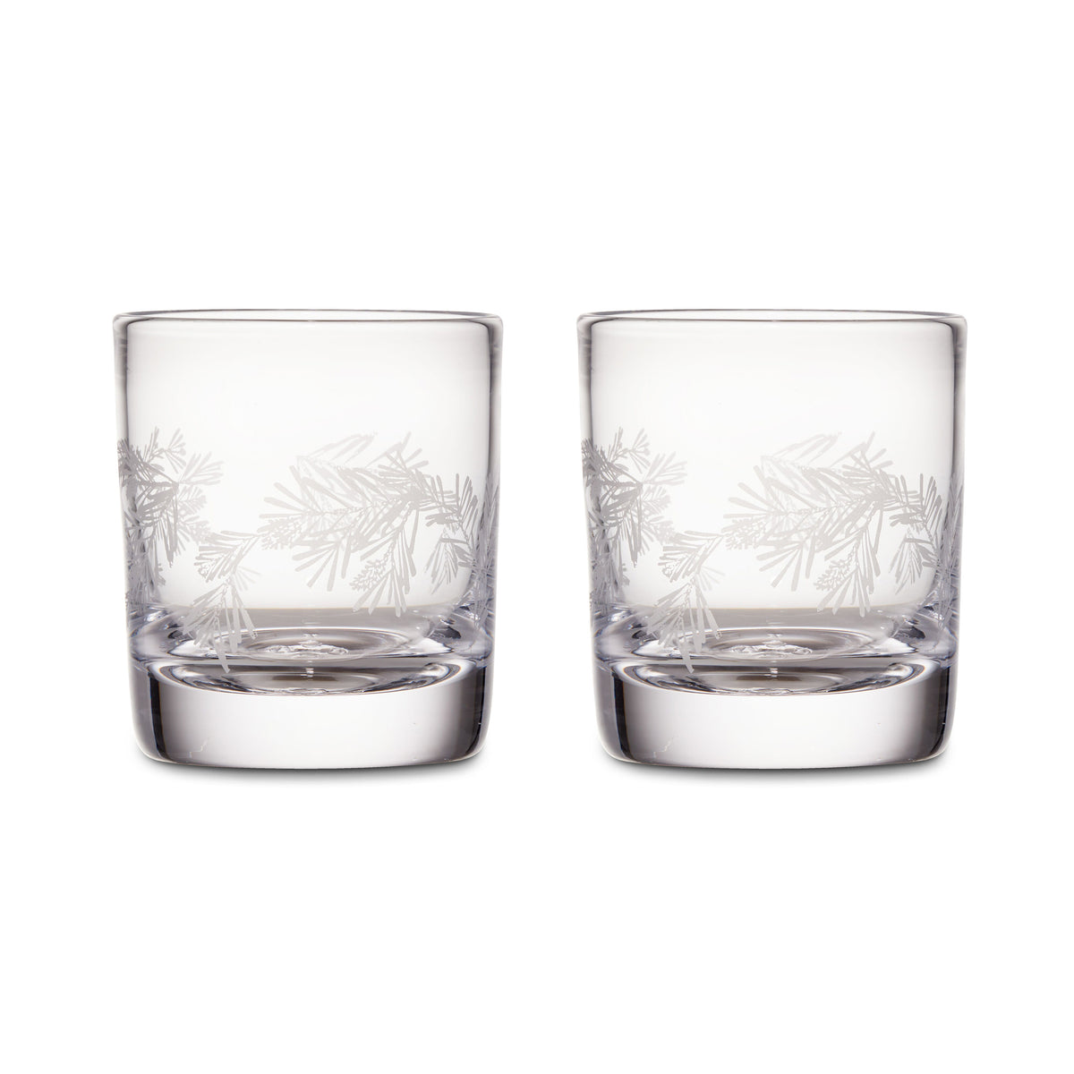 Two clear double old-fashioned glasses with engraved pine needle design around the upper portion.