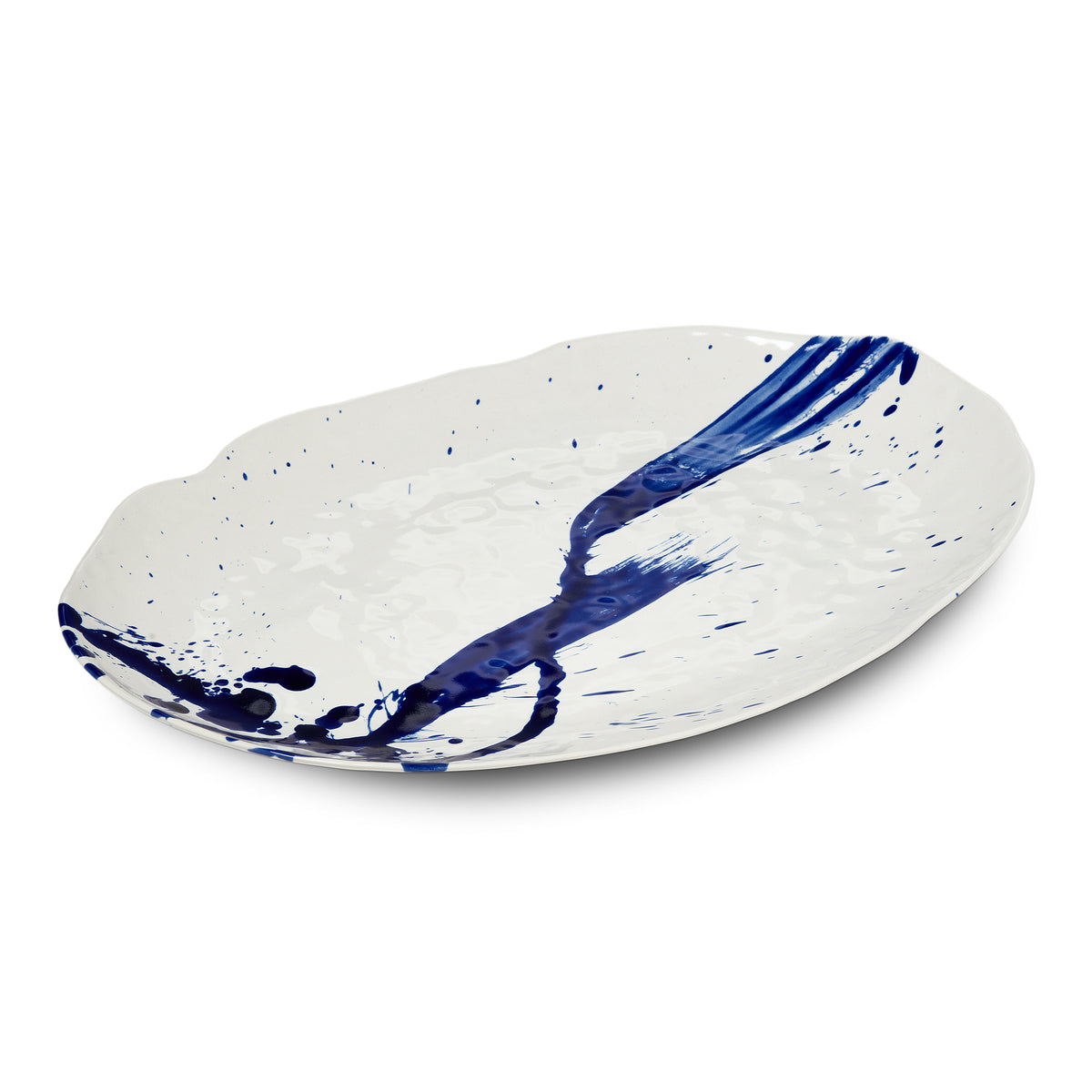 White oval platter with blue brushstroke design and speckled pattern throughout.